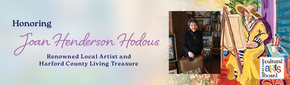 A promotional banner honoring Joan Henderson Hodous, a renowned local artist and Harford County Living Treasure. The banner features elegant text that reads 'Honoring Joan Henderson Hodous – Renowned Local Artist and Harford County Living Treasure' on a pastel gradient background. To the right, there is a photo of Joan Henderson Hodous standing in a warmly decorated room, and beside it, a vibrant painting of a woman in a yellow outfit painting at an easel. The Harford County Cultural Arts Board logo appears in the lower right corner.